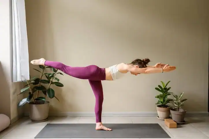 Woman doing Yoga exercise Buckingham to help with toning the body. 